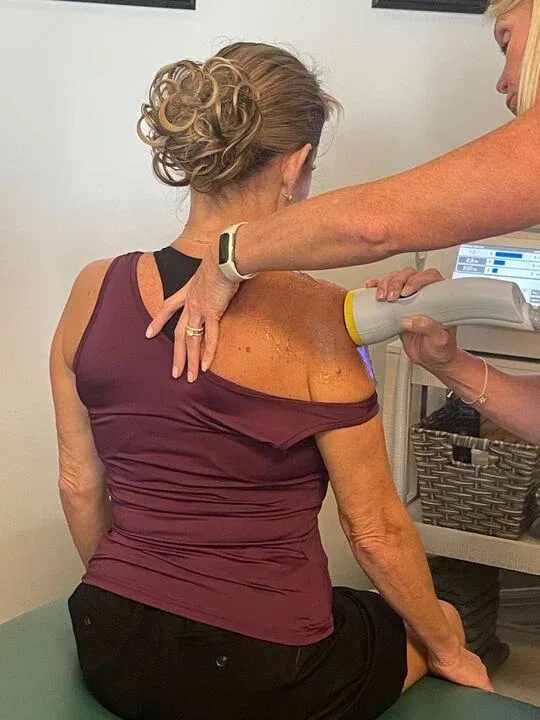 SoftWave therapy on a patient's shoulder