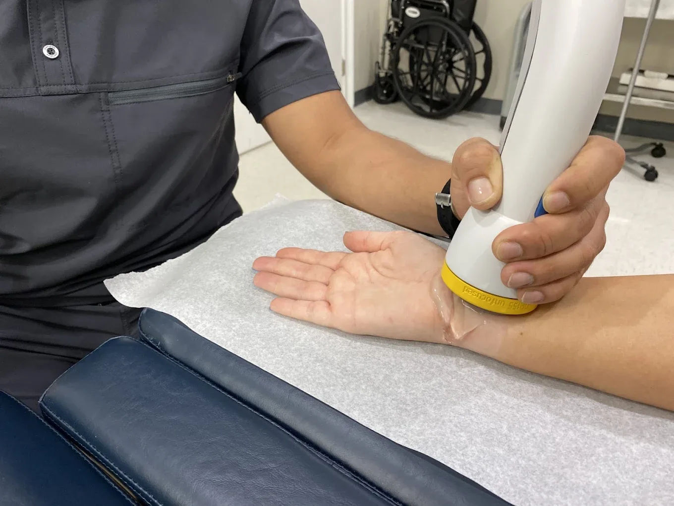 SoftWave therapy applied to a patient's wrist
